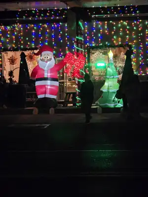 Downtown storefront decorated with colorful Christmas lights