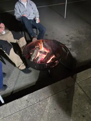 Community gathering around a warm fire pit
